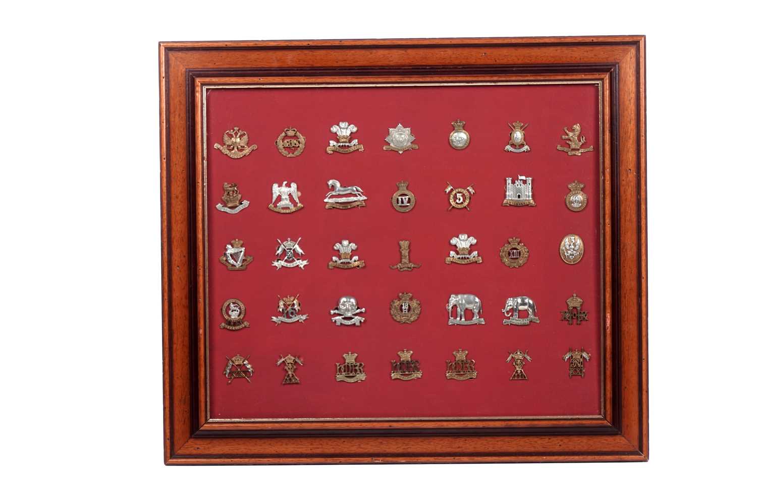Lot 184 - A display of British regimental cap badges, mainly Dragoons, Lancers and Hussars