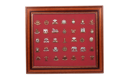 Lot 184 - A display of British regimental cap badges, mainly Dragoons, Lancers and Hussars
