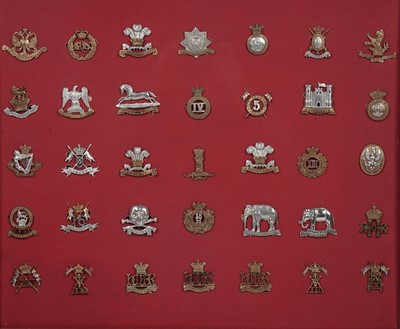 Lot 184 - A display of British regimental cap badges, mainly Dragoons, Lancers and Hussars