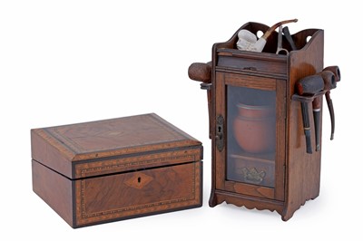 Lot 204 - An Edwardian oak smoker’s cabinet with a selection of pipes; and a writing slope
