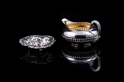 Lot 297 - A George IV silver cream jug retailed by Garrards & Co.; and a Victorian silver bonbon dish