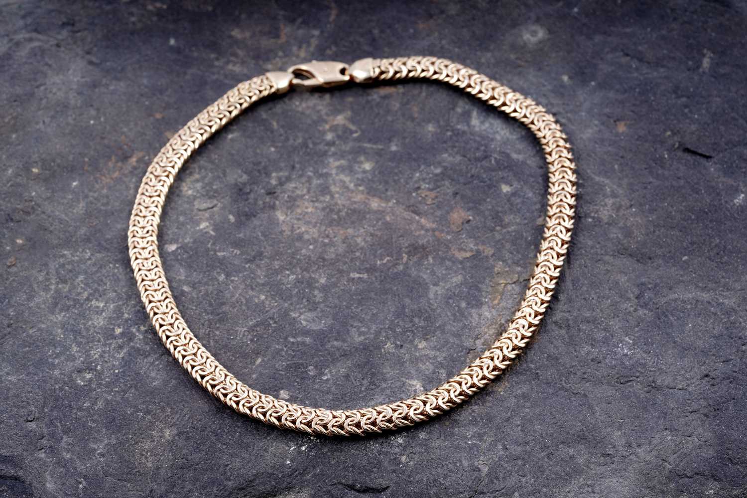 Lot 165 - A contemporary 9ct gold woven necklace
