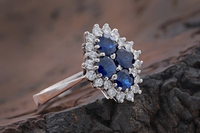 Lot 741 - A sapphire and diamond cluster ring