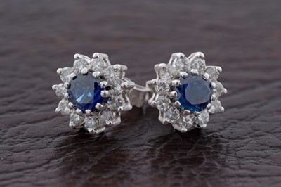 Lot 742 - A pair of sapphire and diamond cluster earrings