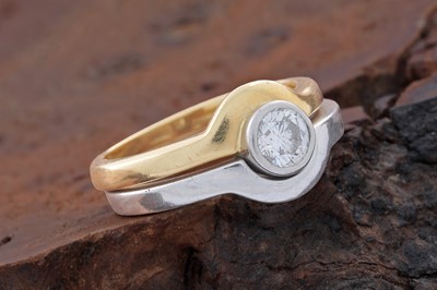 Lot 748 - A single-stone diamond ring with fitted wedding band