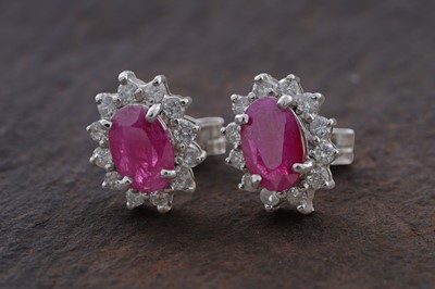 Lot 94 - A pair of ruby and diamond cluster earrings