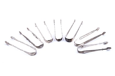 Lot 476 - Six various pairs of George III silver “cast arm” sugar tongs