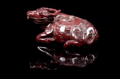 Lot 353 - A Chinese carved red jasper water buffalo