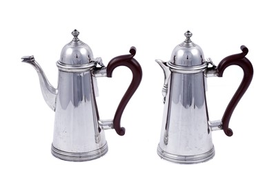 Lot 148 - A pair of George V silver café au lait pots