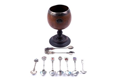 Lot 292 - A 19th Century coconut cup; and a collection of enamelled silver souvenir spoons
