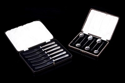 Lot 242 - A cased set of six silver coffee spoons; and a set of six silver handled tea knives