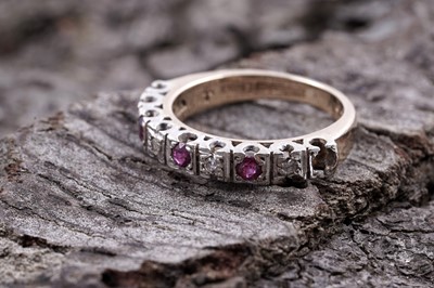 Lot 80 - A 1970s ruby and diamond half hoop eternity ring