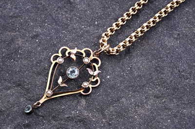 Lot 191 - An Edwardian aquamarine and split seed pearl openwork pendant on chain