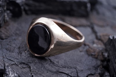Lot 104 - A 1970s black onyx and 9ct gold signet ring