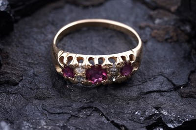 Lot 63 - An Edwardian style three-stone ruby and diamond ring