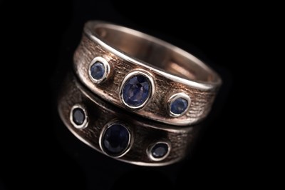 Lot 64 - A contemporary three-stone sapphire ring