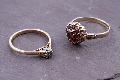 Lot 67 - A single stone illusion-set diamond ring; and a garnet flowerhead pattern ring