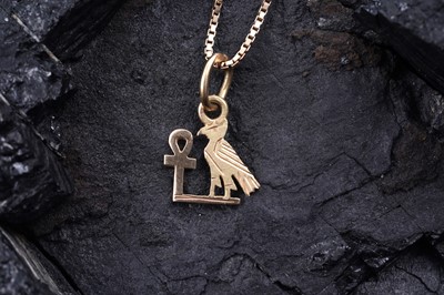 Lot 16 - An Egyptian 18ct gold Ankh and bird of wisdom pendant on chain