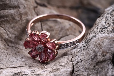 Lot 158 - A contemporary lab-grown Padparadscha sapphire and diamond flowerhead cocktail ring