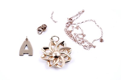 Lot 163 - A 14ct gold flowerhead pattern pendant; a letter "A" pendant; a safety chain; and another