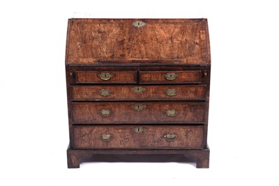 Lot 624 - A George II feather banded walnut bureau
