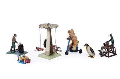 Lot 587 - A collection of tinplate clockwork toys