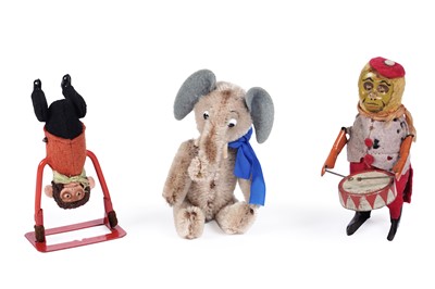 Lot 588 - A Schuco plush Yes/No Elephant;a Schuco Tumbling Monkey; and a clockwork drumming monkey