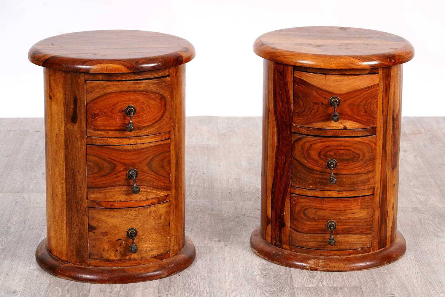 Lot 30 - A pair of contemporary hardwood cylindrical bedside chests