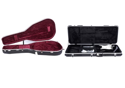 Lot 254 - Two guitar cases; and a Strat-style body