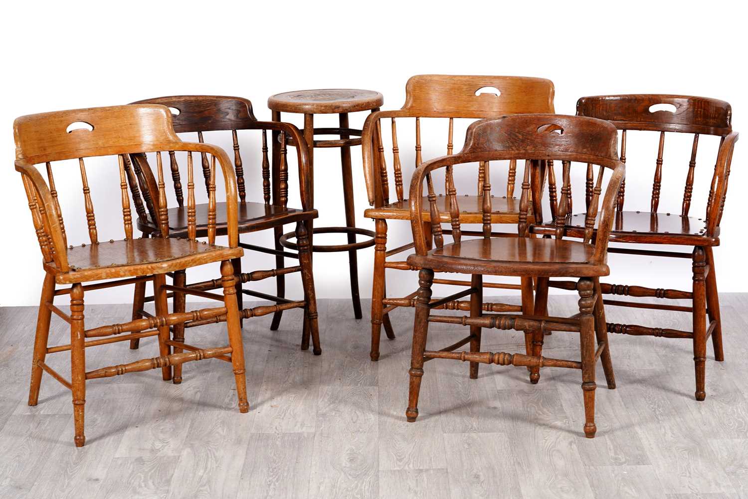 Lot 37 - Five early 20th-century oak captain's low-backed Windsor chairs