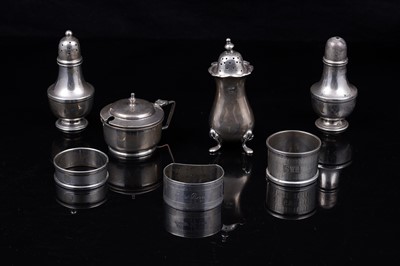 Lot 217 - An Elizabeth II silver three piece cruet set; a pepperette; and napkin rings