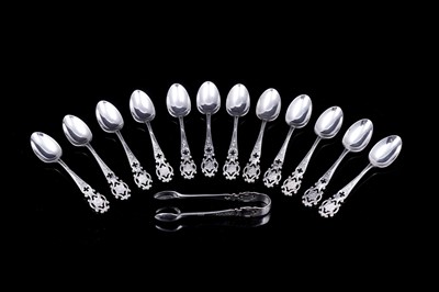 Lot 207 - A set of twelve Edwardian silver coffee spoons and sugar tongs of Gothic influence