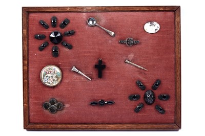 Lot 38 - A framed display of Victorian and later jewellery and accoutrements