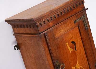 Lot 56 - An Arts & Crafts style mahogany hanging cabinet