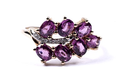 Lot 79 - A contemporary comeria garnet and diamond ring