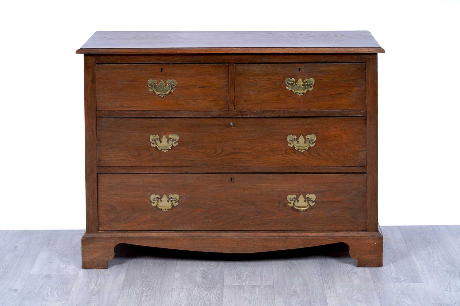 Lot 10 - A Georgian-style oak chest of drawers