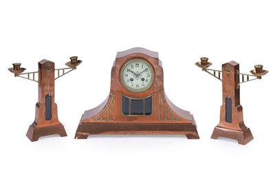 Lot 577 - An early 20th Century Arts and Crafts mantle clock and garnitures