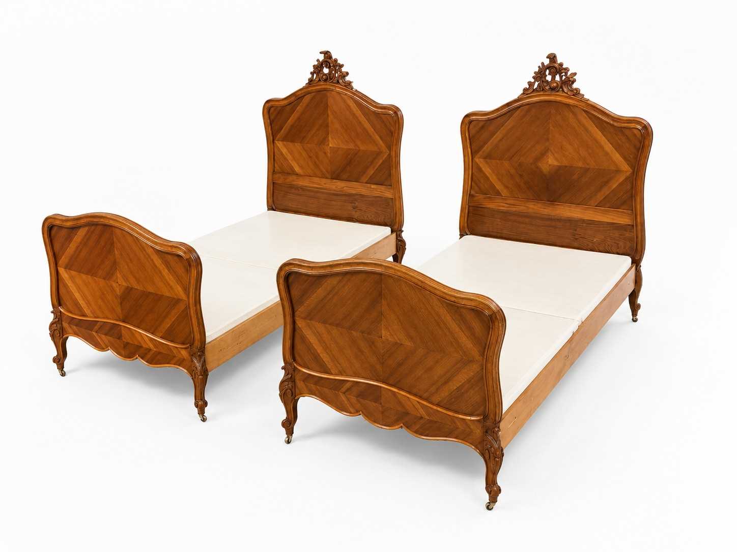 Lot 77 - A pair of French Rococo style walnut beds