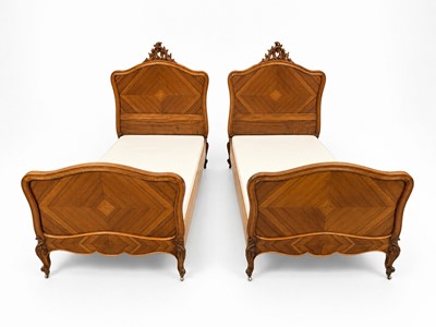 Lot 77 - A pair of French Rococo style walnut beds