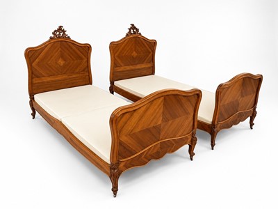 Lot 77 - A pair of French Rococo style walnut beds