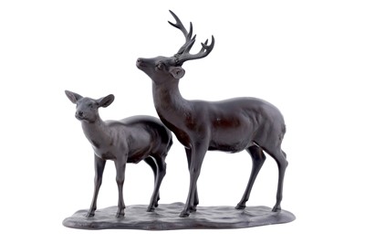 Lot 203 - An early 20th Century Oriental bronze figure group of a male and female deer