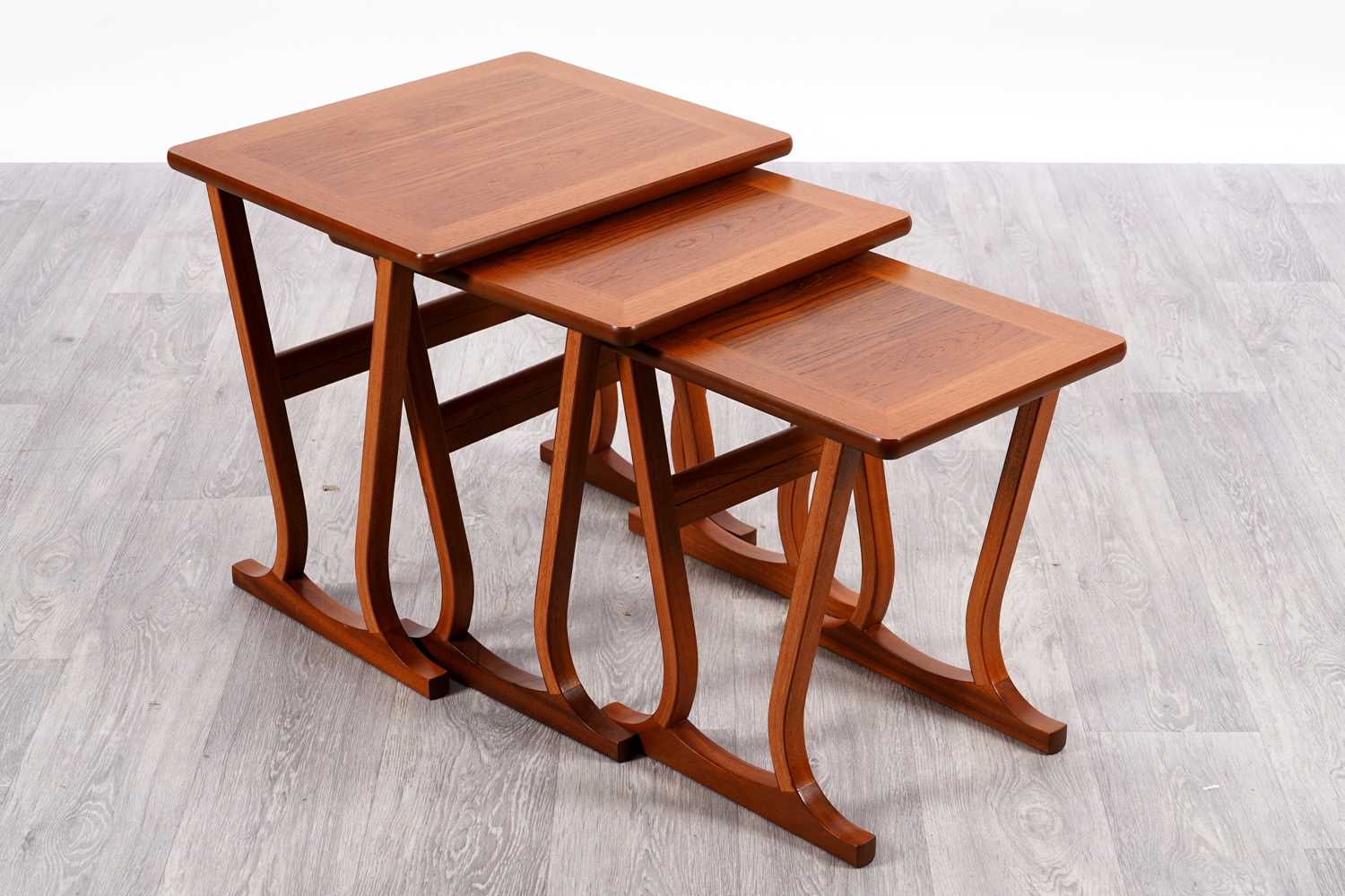 Lot 107 - A Nathan mid-Century nest of three teak tables