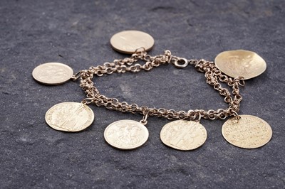 Lot 296 - A fancy figaro-link bracelet; and seven pendant coins