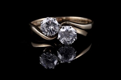 Lot 477 - A two-stone diamond crossover ring