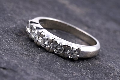 Lot 18 - A diamond five-stone half-hoop eternity ring