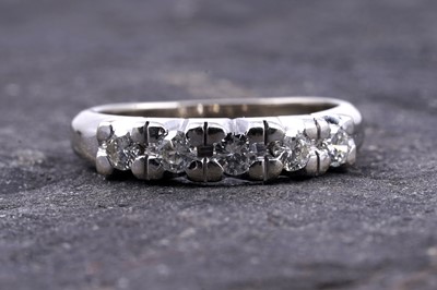 Lot 18 - A diamond five-stone half-hoop eternity ring