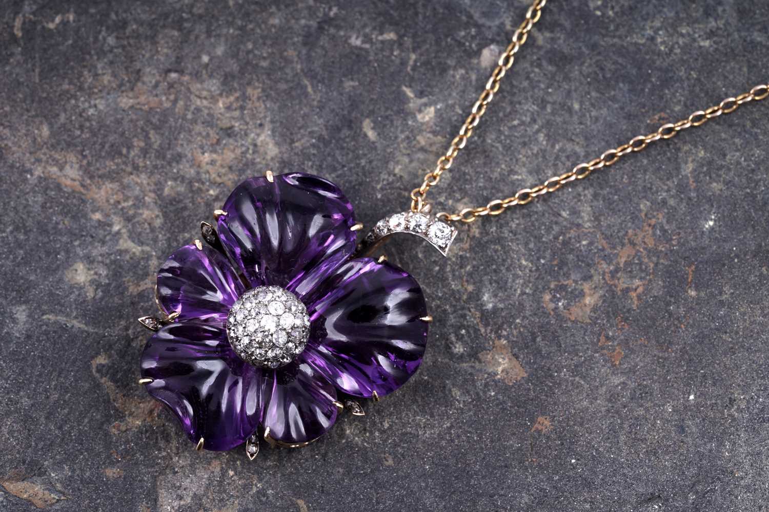 Lot 524 - A late Victorian carved amethyst and diamond pansy pendant