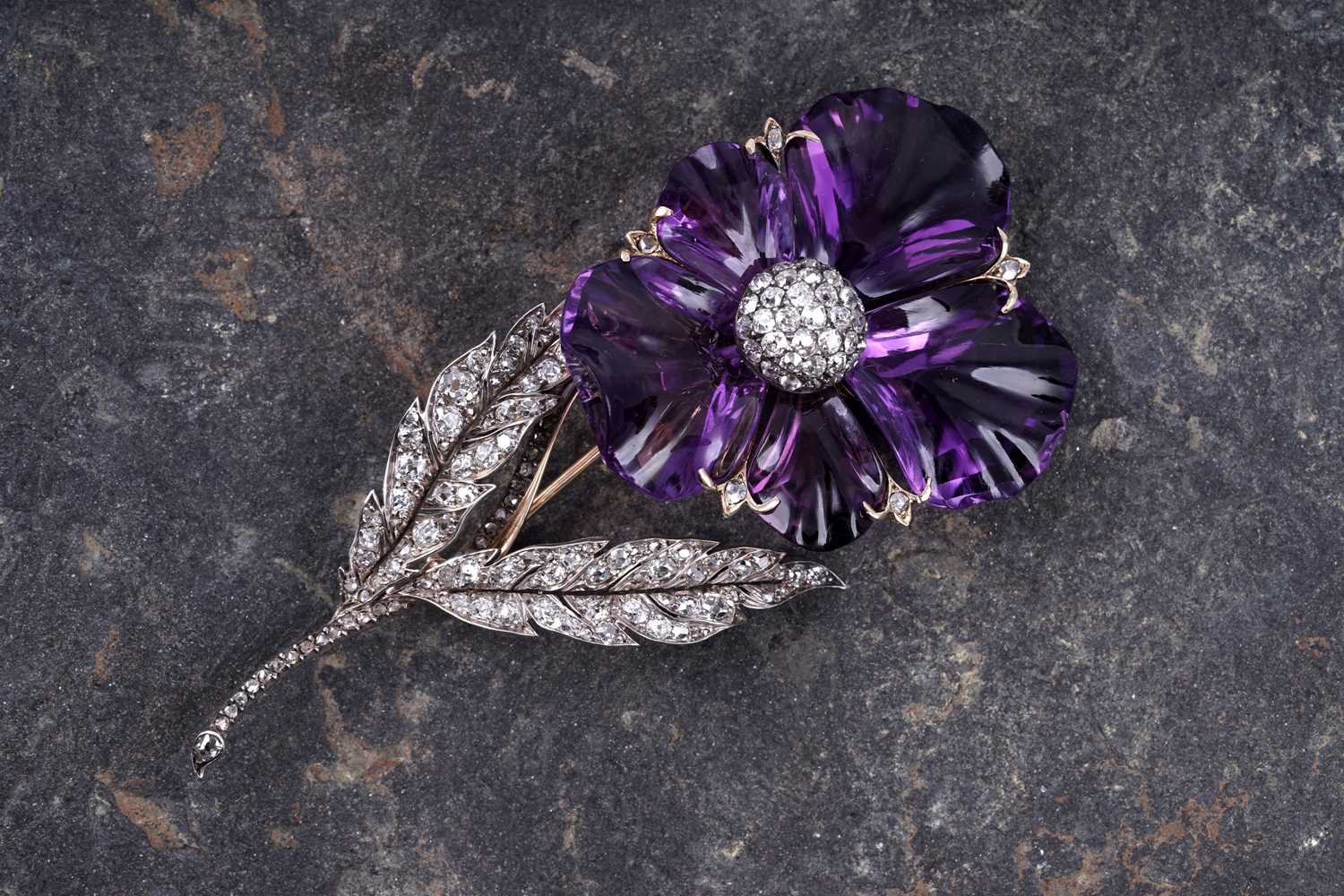 Lot 525 - A late Victorian carved amethyst and diamond pansy brooch