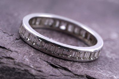 Lot 535 - A baguette-cut diamond eternity ring