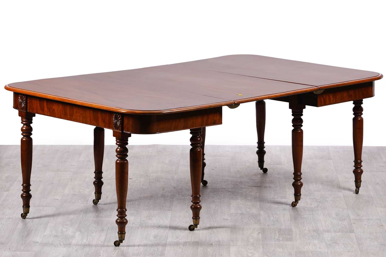 Lot 21 - A late Georgian mahogany dining table
